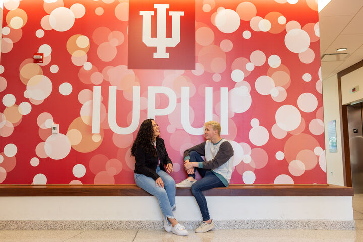 Two IU Indianapolis students chatting in the lobby of North Hall